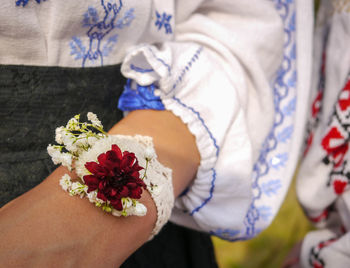 Midsection of woman holding bouquet