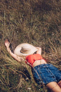 Young woman lying on field