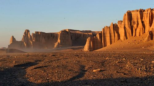 Panoramic view of desert against sky during sunset