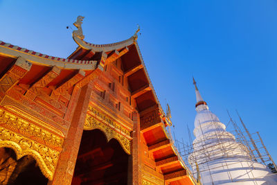 Low angle view of temple building against blue sky