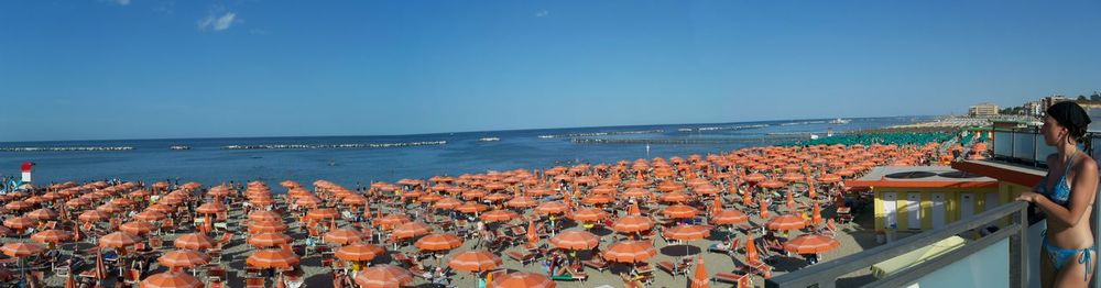 Panoramic view of beach against clear blue sky