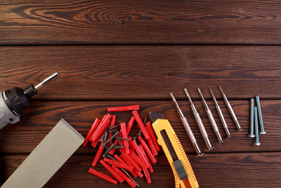 Tools worker, hammer, screwdriver, pliers on a wooden background, top view
