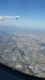 Aerial view of aircraft wing seen through airplane window
