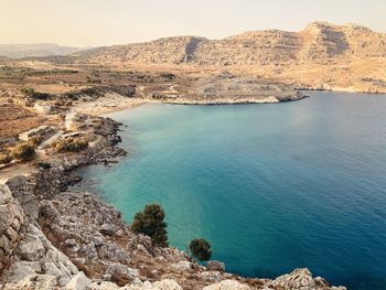 High angle view of rocks by sea against sky in rhodes island, greece. 