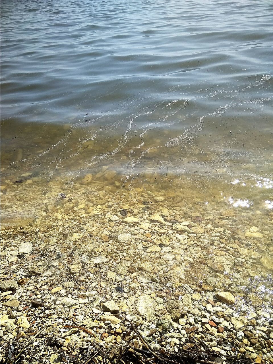 water, beach, sea, no people, nature, beauty in nature, land, day, tranquility, high angle view, outdoors, rock, motion, solid, stone, tranquil scene, shallow, scenics - nature, rock - object, pebble, pollution