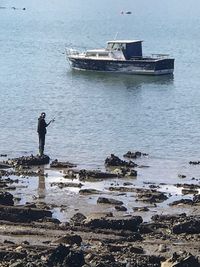 Man standing on sea against sky