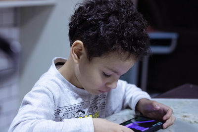Side view of young man using mobile phone