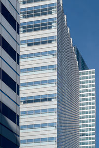 Low angle view of modern buildings in city against sky