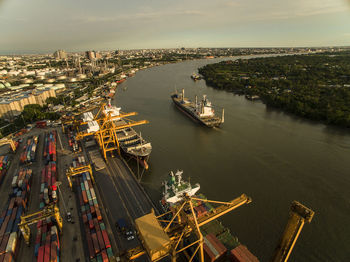 High angle view of cityscape by sea against sky