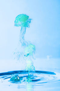 Close-up of water splashing against blue background