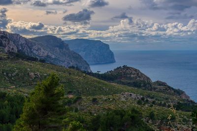 Scenic view of sea and mountains against sky