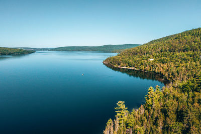 Scenic view of lake against clear blue sky