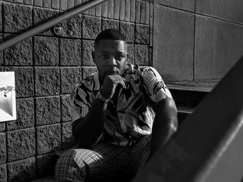 Portrait of young man sitting outdoors