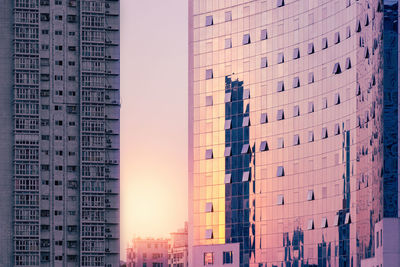 Low angle view of buildings against sky during sunset