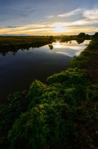 Scenic view of lake against sky during sunset