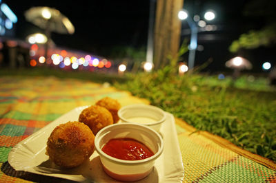 Close-up of served food on table at night