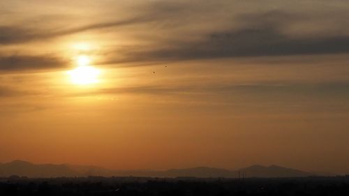 Scenic view of silhouette landscape against romantic sky at sunset