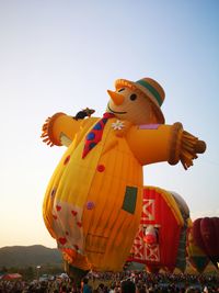 Low angle view of sculpture at amusement park against clear sky