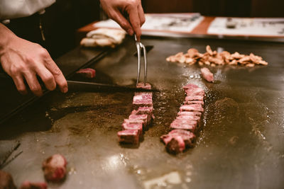 Midsection of person preparing food in kitchen