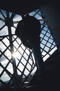 Low angle view of silhouette woman against sky