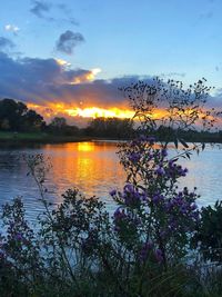 Scenic view of lake against sky during sunset