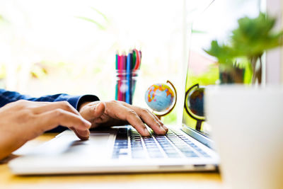 Midsection of woman working on table