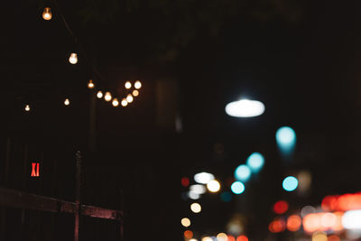 Defocused image of illuminated street lights at night