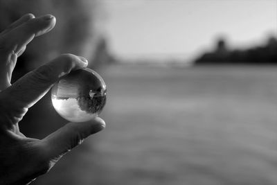 Close-up of hand holding crystal ball