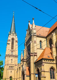 Low angle view of historic building against clear blue sky