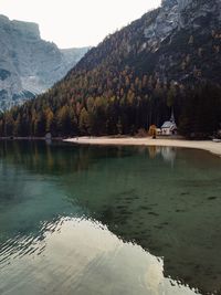 Scenic view of lake by trees against sky