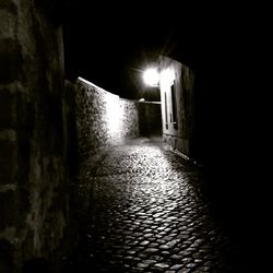 Illuminated walkway at night