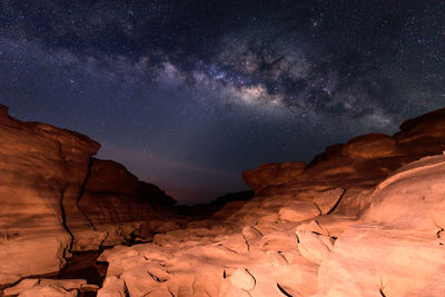 Scenic view of rock formation against sky at night