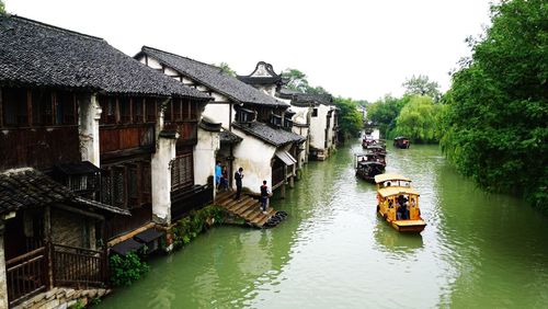 Boats in river with buildings in background