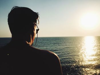 Portrait of man in sea against sky during sunset