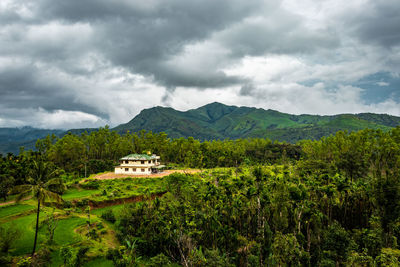 House at remote village isolated with mountain coverd clouds and green forests 