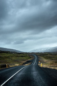 Road passing through landscape against sky