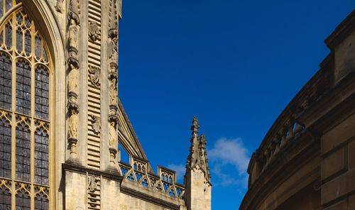 Low angle view of buildings against blue sky