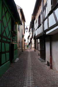 Empty alley amidst buildings in city