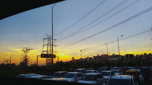 View of traffic in city during sunset