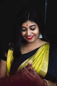 Smiling young woman in traditional clothing