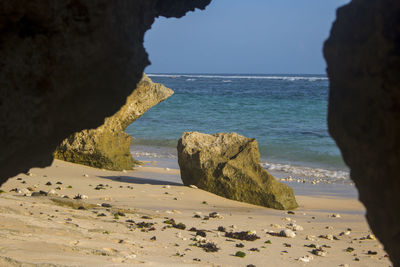Rocks on beach against sky