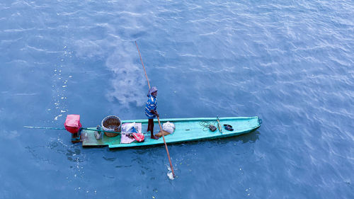 High angle view of people on boat in sea