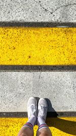 Low section of person standing on road