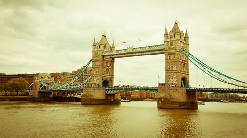 View of bridge over river against cloudy sky