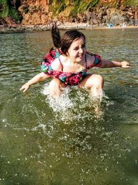 Cute girl splashing in lake