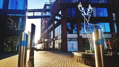City street by buildings against sky