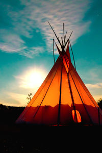 View of teepee against sky at sunset