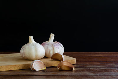 Close-up of pumpkins on table against black background