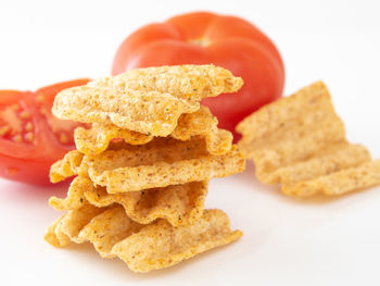 Close-up of bread in plate against white background