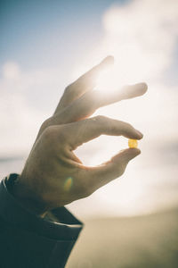 Close-up of human hand on snow covered beach